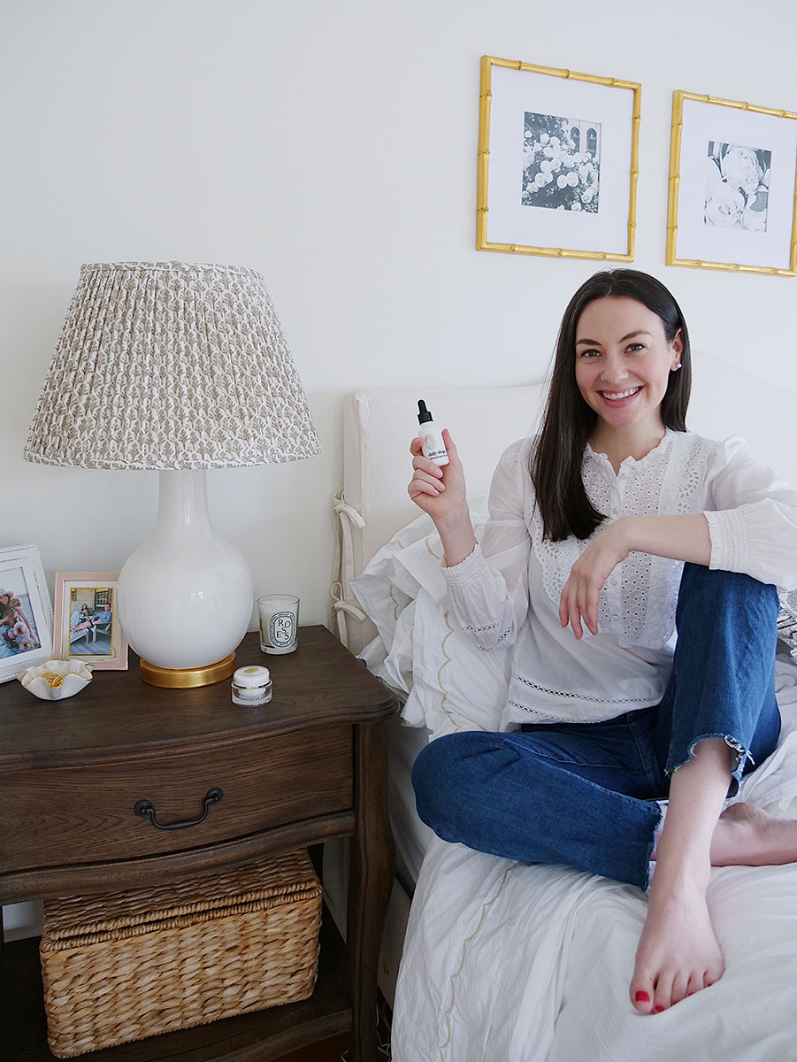New Jersey blogger Carly Heitlinger holding a bottle of CBD oil